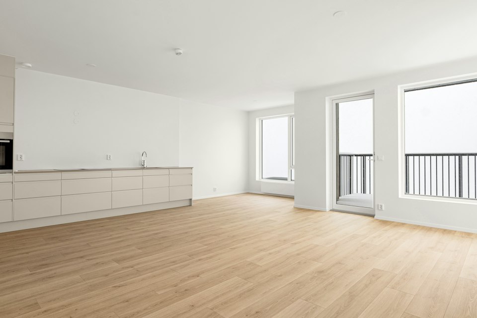 Empty living room showcasing hardwood floor